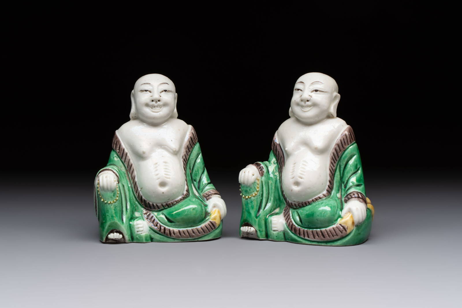 A pair of Chinese verte biscuit Milefo Buddhas, 19th C.