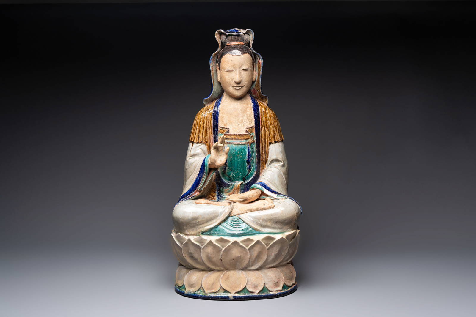A large Chinese polychrome-glazed Shiwan stoneware figure of Guanyin, 19th C.