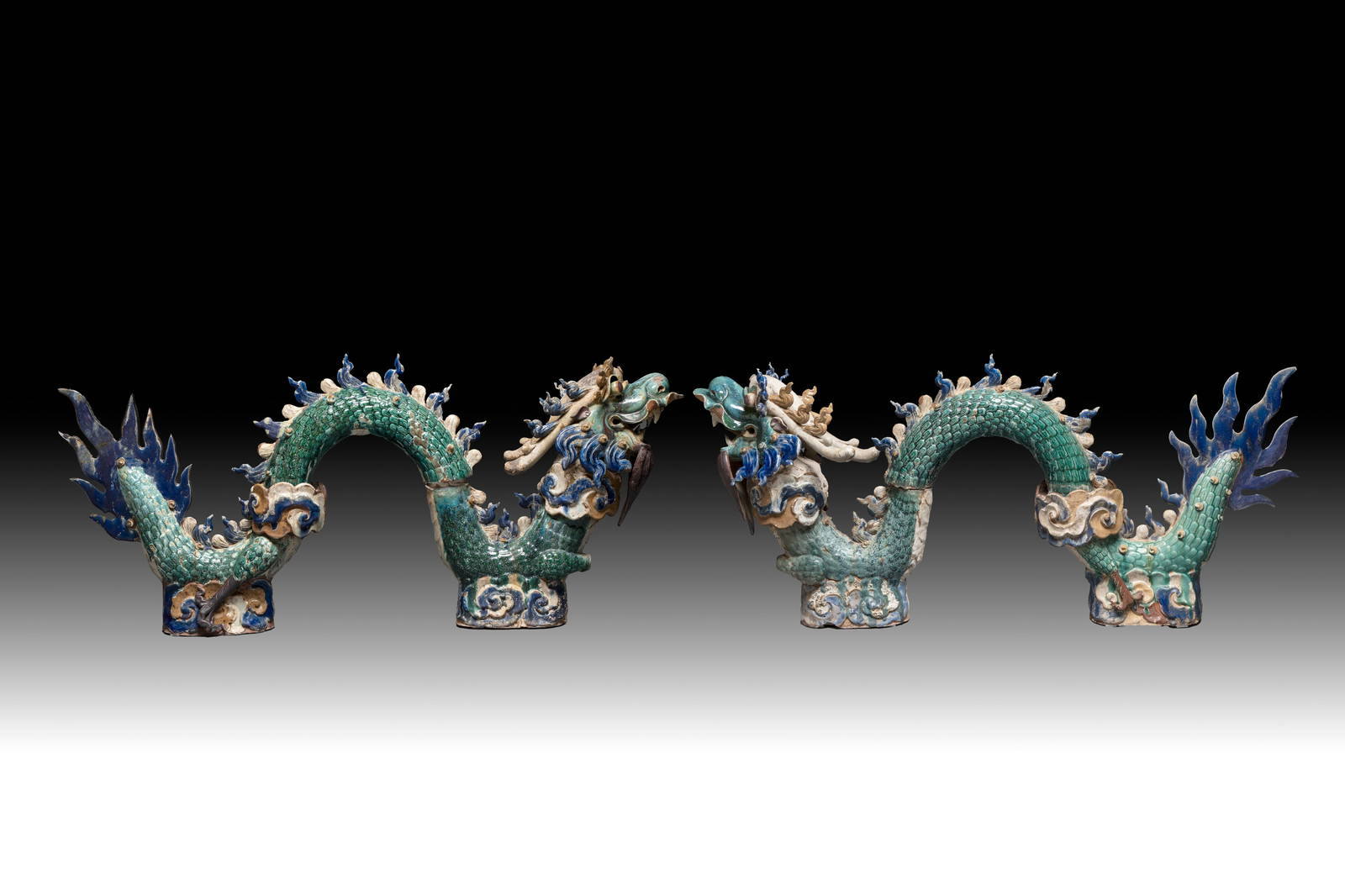 A pair of large Chinese polychrome-glazed Shiwan stoneware dragons, 19th C.