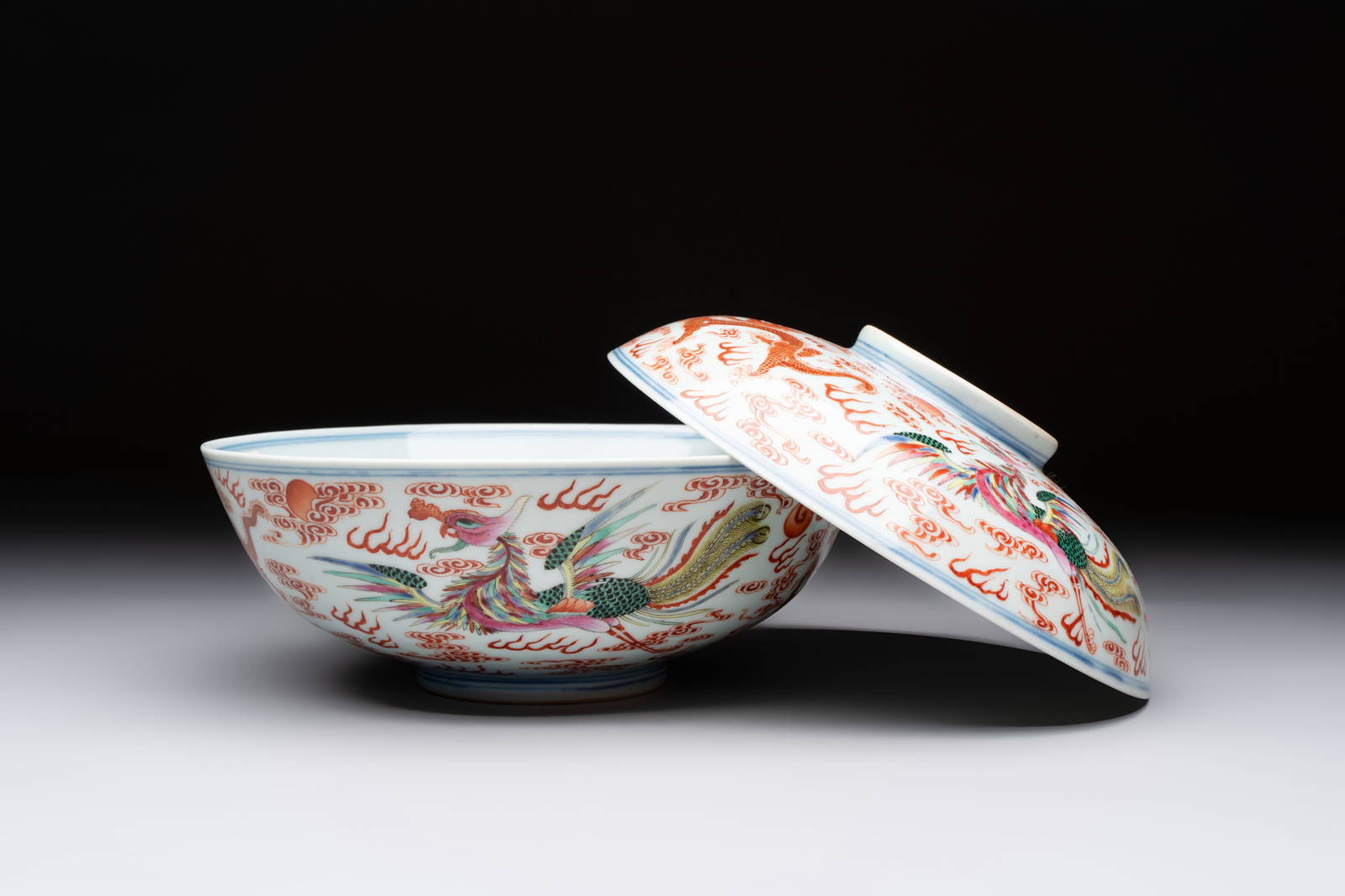 A Chinese famille rose 'dragon and phoenix' bowl and cover, Jiaqing mark and of the period