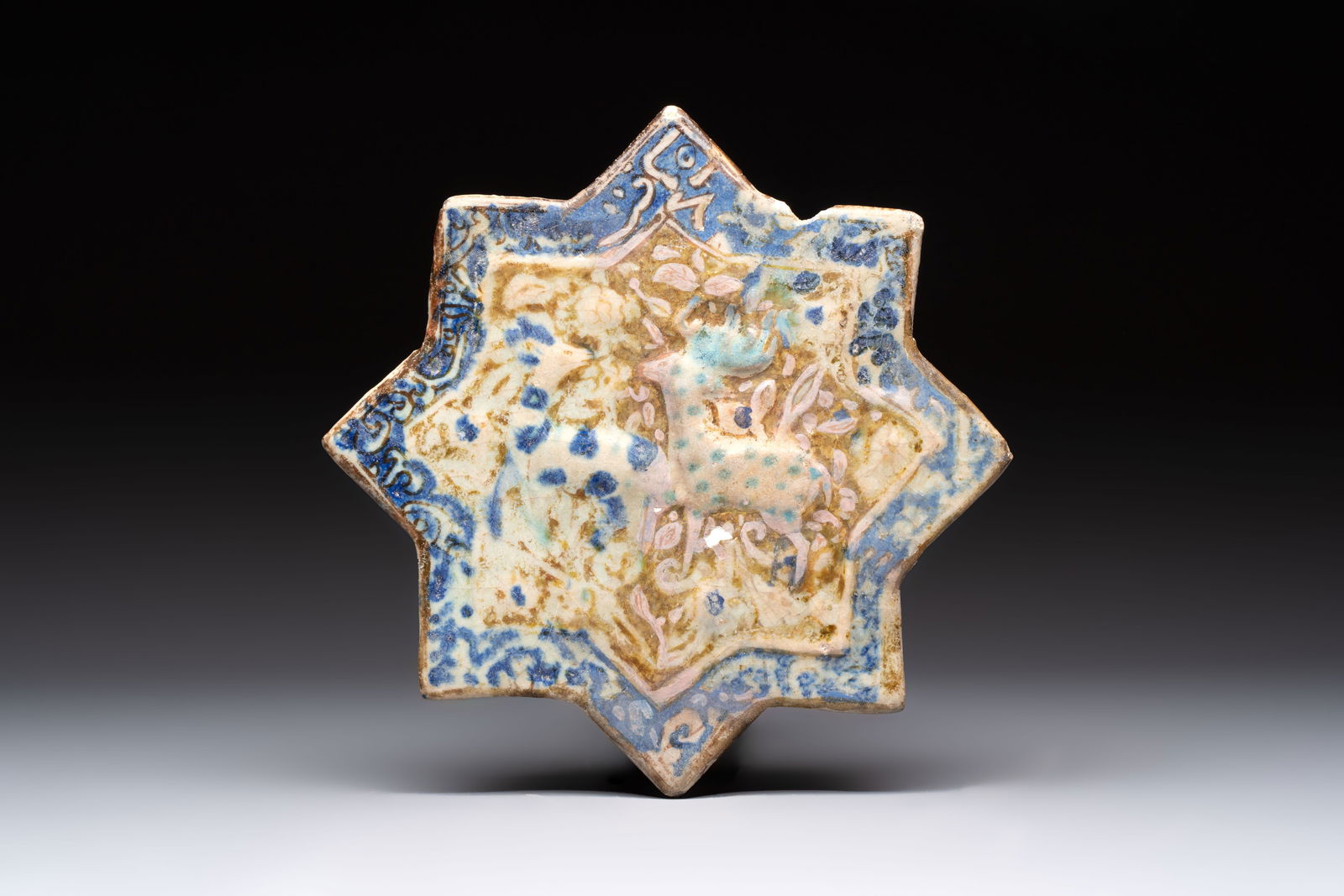 A Kashan lustre-glazed relief-moulded star tile, Iran, 13th C. (1 of 2)