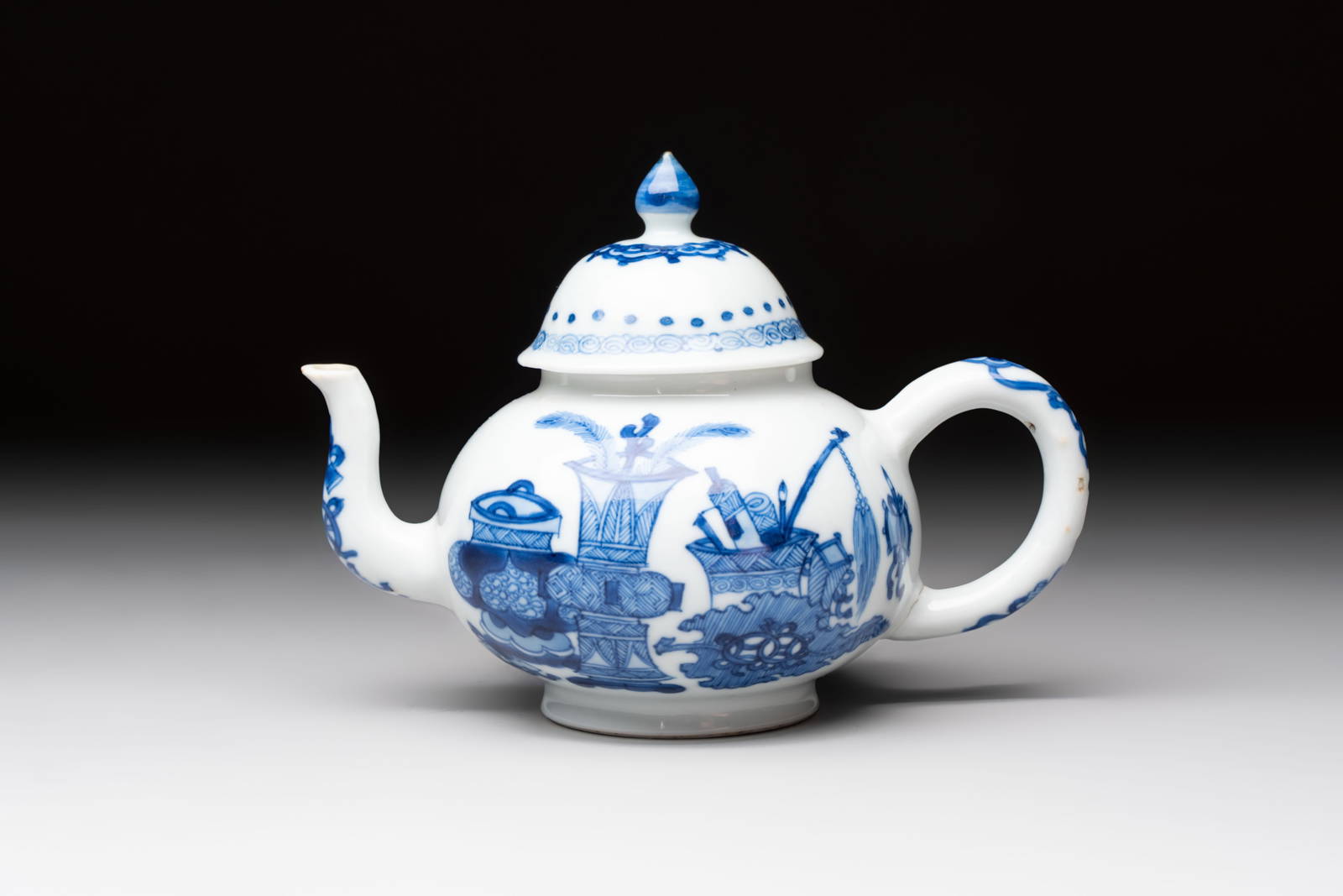 A Chinese blue and white 'antiquities' teapot and cover, Jiajing mark, Kangxi