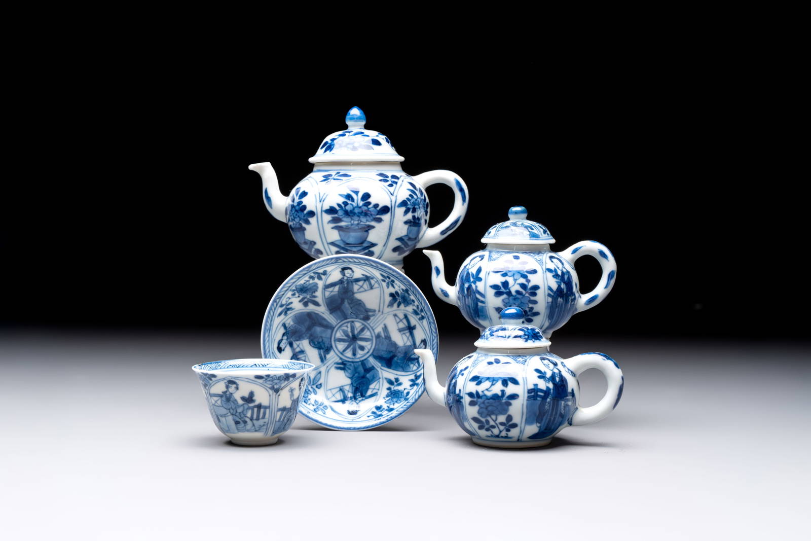 Three Chinese blue and white teapots, a cup and a saucer, Kangxi