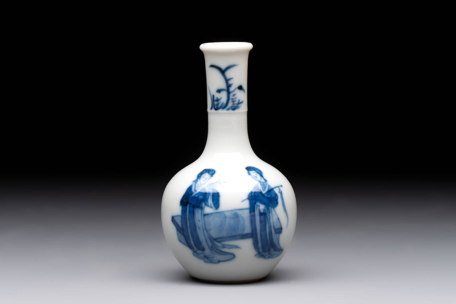 A fine Chinese blue and white miniature bottle vase with two ladies in a garden, jade mark, Kangxi