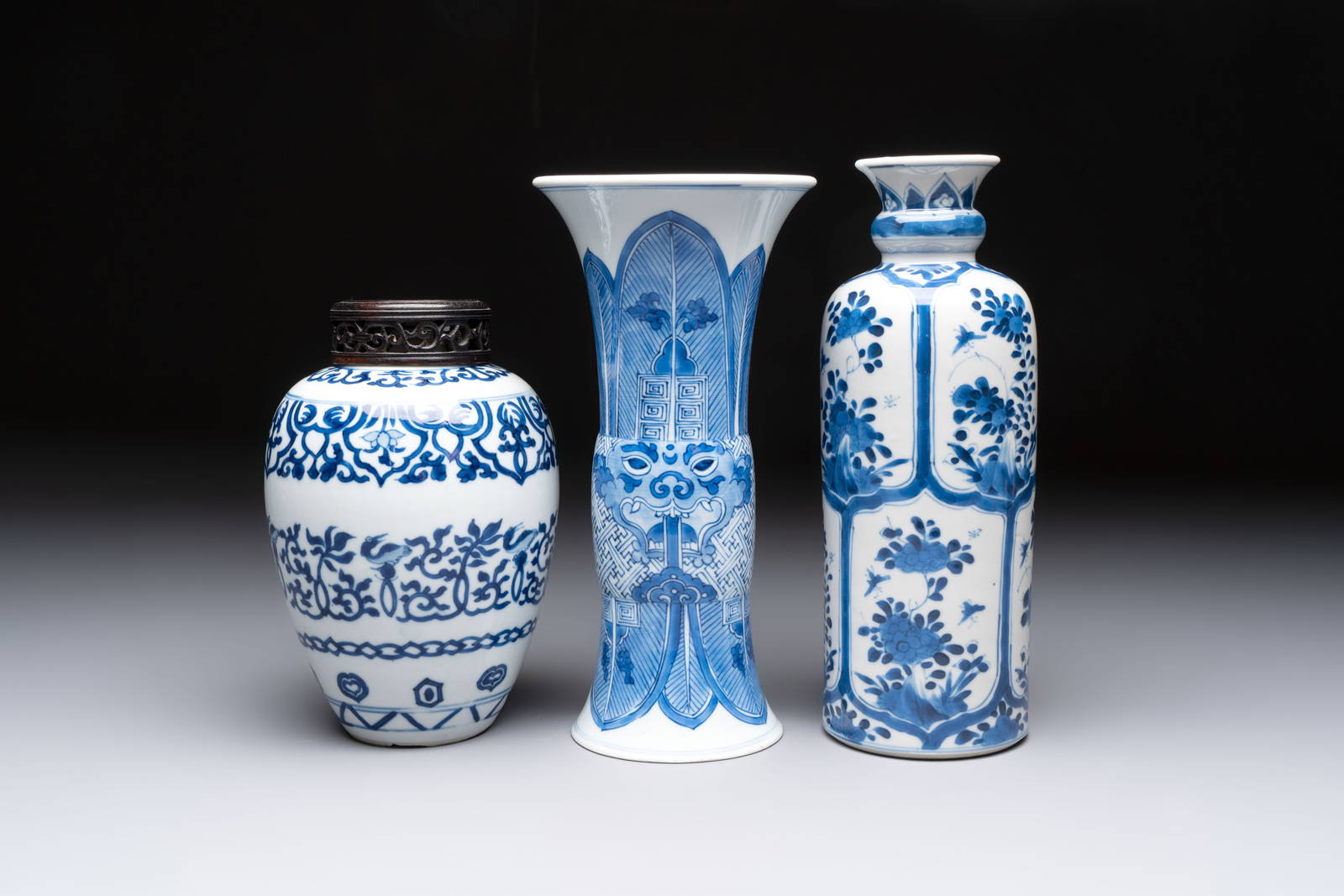 Three Chinese blue and white vases, one with wooden cover, Kangxi