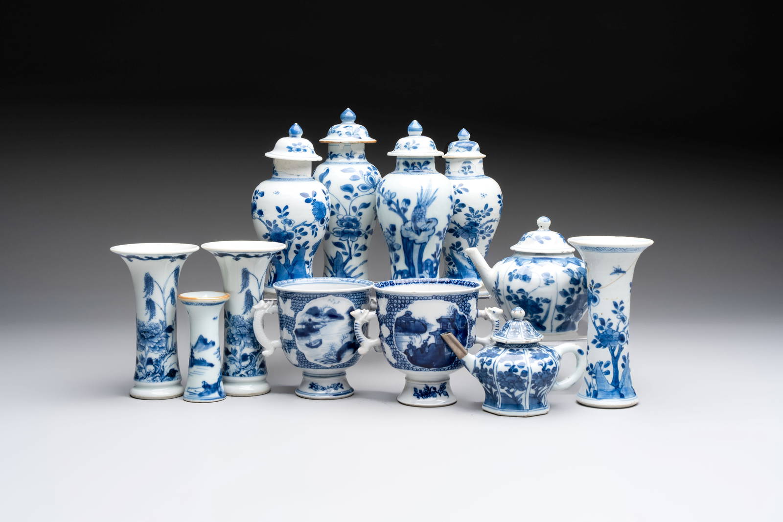 A varied collection of eight Chinese blue and white vases, two teapots and two loving cups,