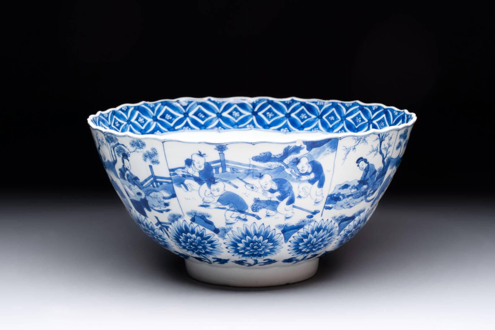 A Chinese blue and white molded bowl with elegant beauties and playing boys, Qi Yu Bao Ding Zhi Zhen