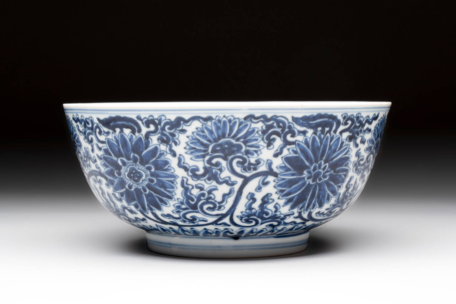 A Chinese blue and white 'lotus scroll' bowl, Xuande mark, Kangxi