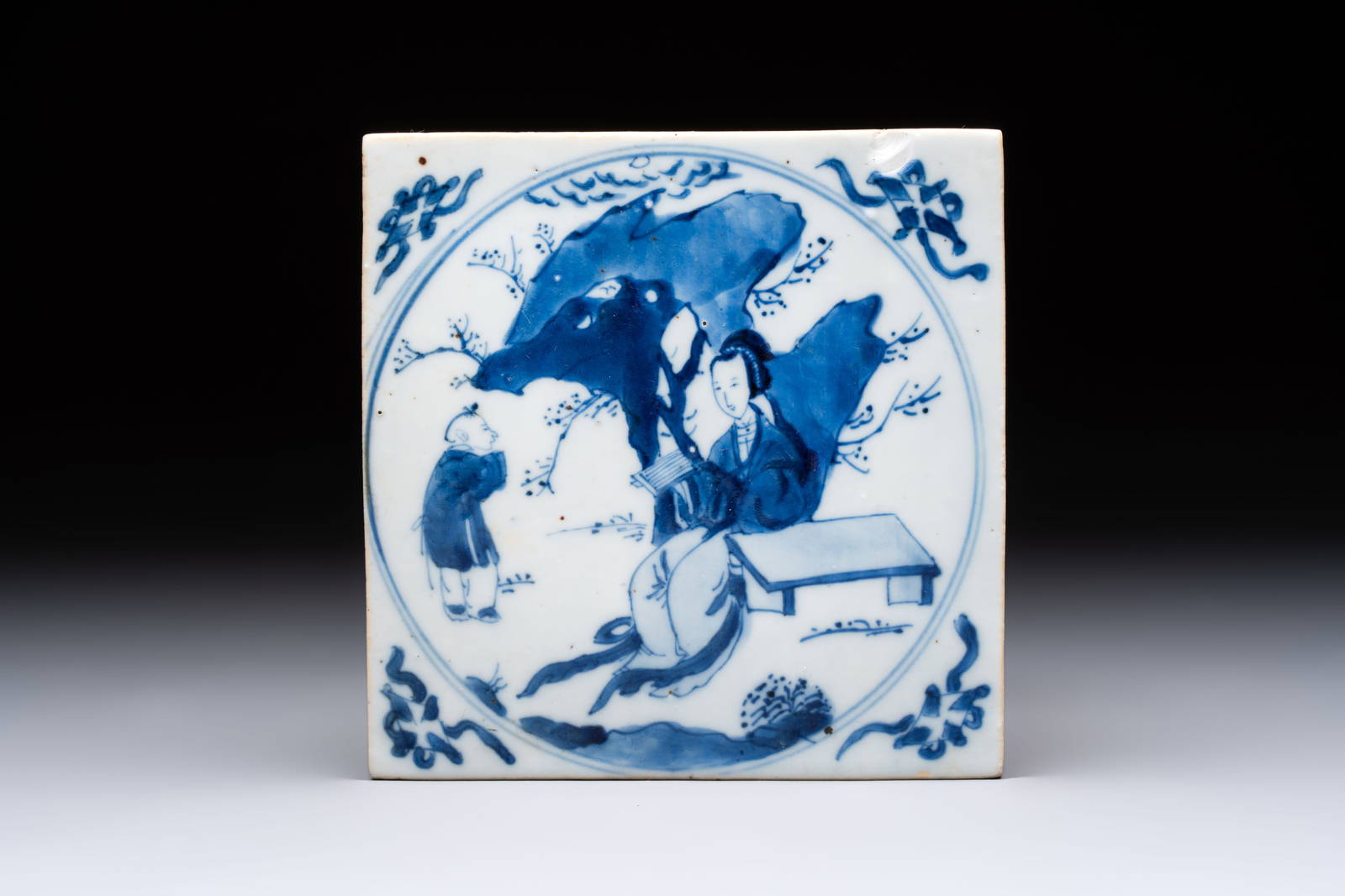A Chinese blue and white 'elegant beauty and boy' tile, Kangxi