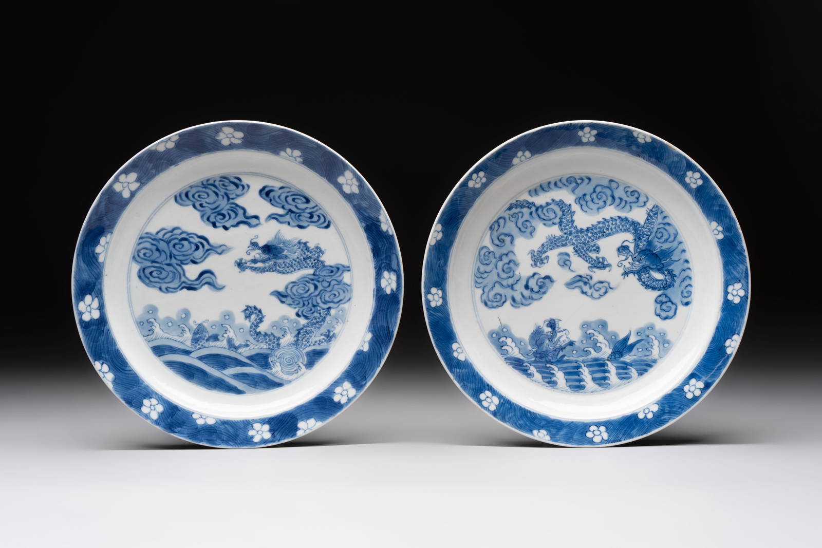 A pair of Chinese blue and white 'dragon' plates, Kangxi mark and of the period