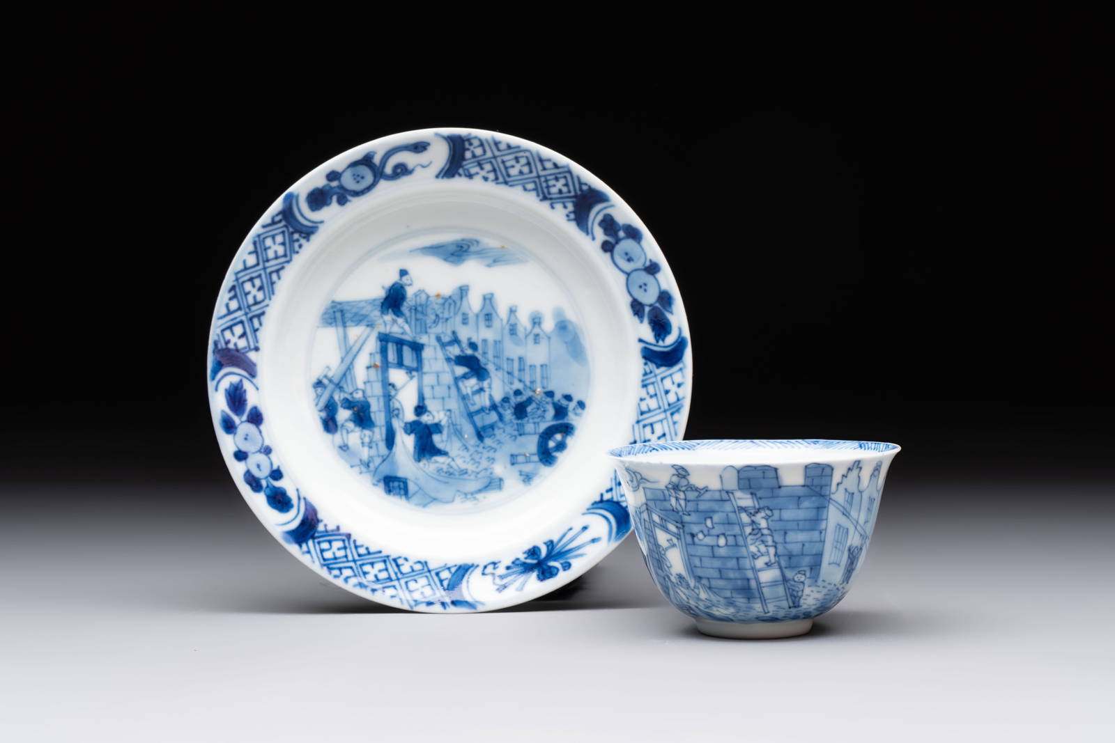 A Chinese blue and white 'Rotterdam Riot' cup and saucer, jade mark, Kangxi