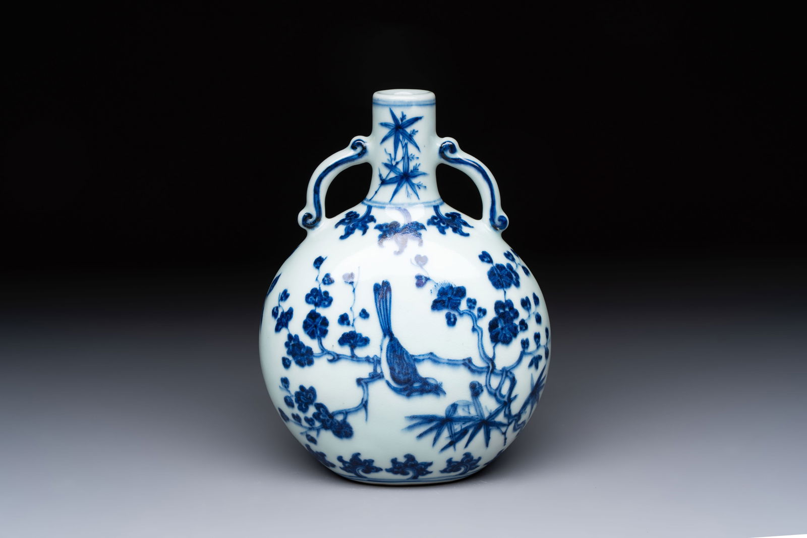 A rare Chinese blue and white moonflask with a bird on a blossoming branch, Yongzheng/Qianlong: A rare Chinese blue and white moonflask with a bird on a blossoming branch, Yongzheng/Qianlong H.: 19 cm Provenance: - A French private collection. Ref.: - Christie's, New York, Sep. 19, 2006, lot 305