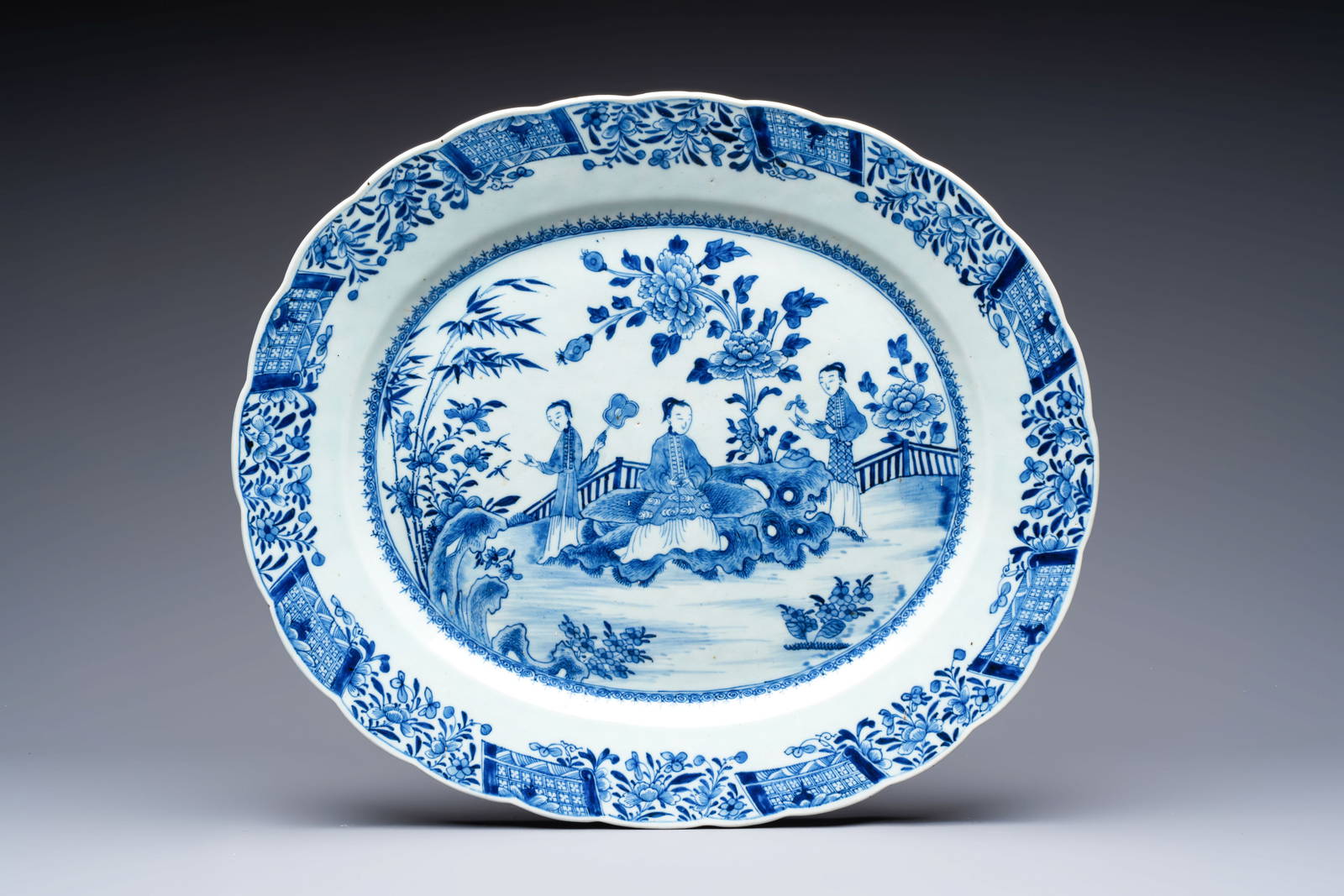 A Chinese blue and white 'ladies in a garden' serving dish, Qianlong