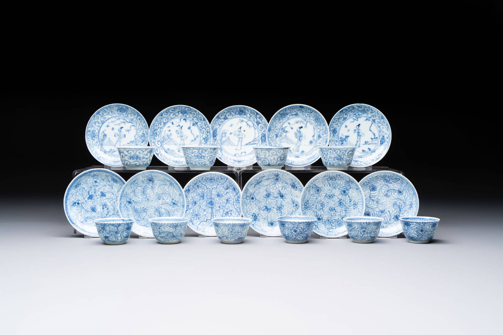 Ten Chinese blue and white cups and eleven saucers, Kangxi