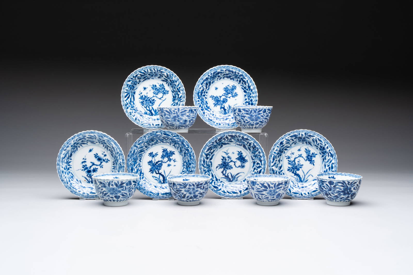 A set of six Chinese blue and white cups and saucers with floral design, Kangxi
