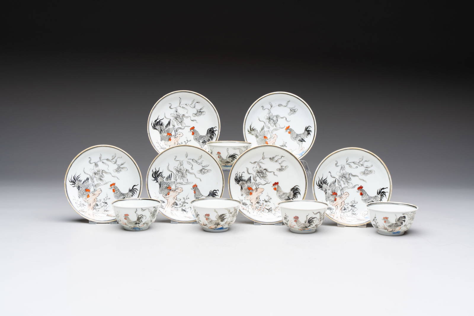 Five Chinese grisaille and iron-red-decorated cups and six saucers with fighting roosters, Yongzheng
