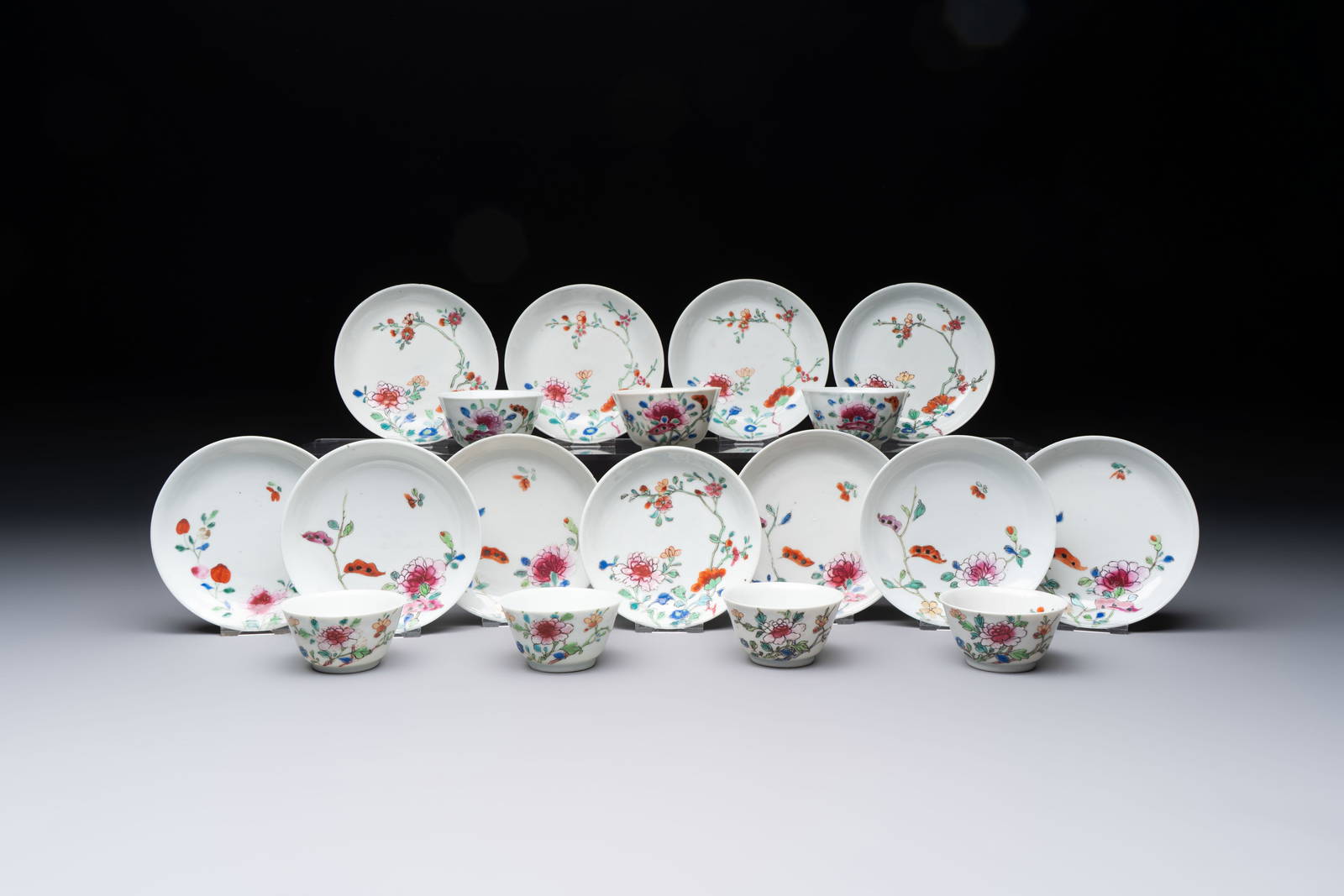 Seven Chinese famille rose cups and eleven saucers with floral design, Qianlong