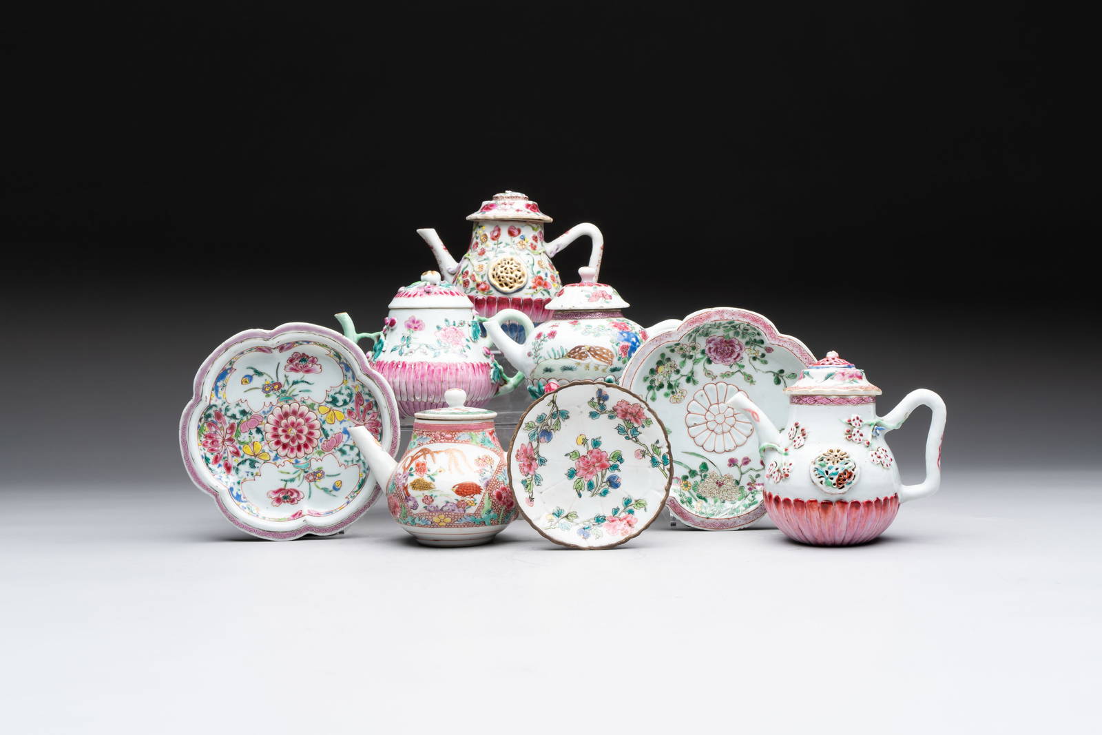 A group of five Chinese famille rose teapots and covers and three stands, Yongzheng/Qianlong