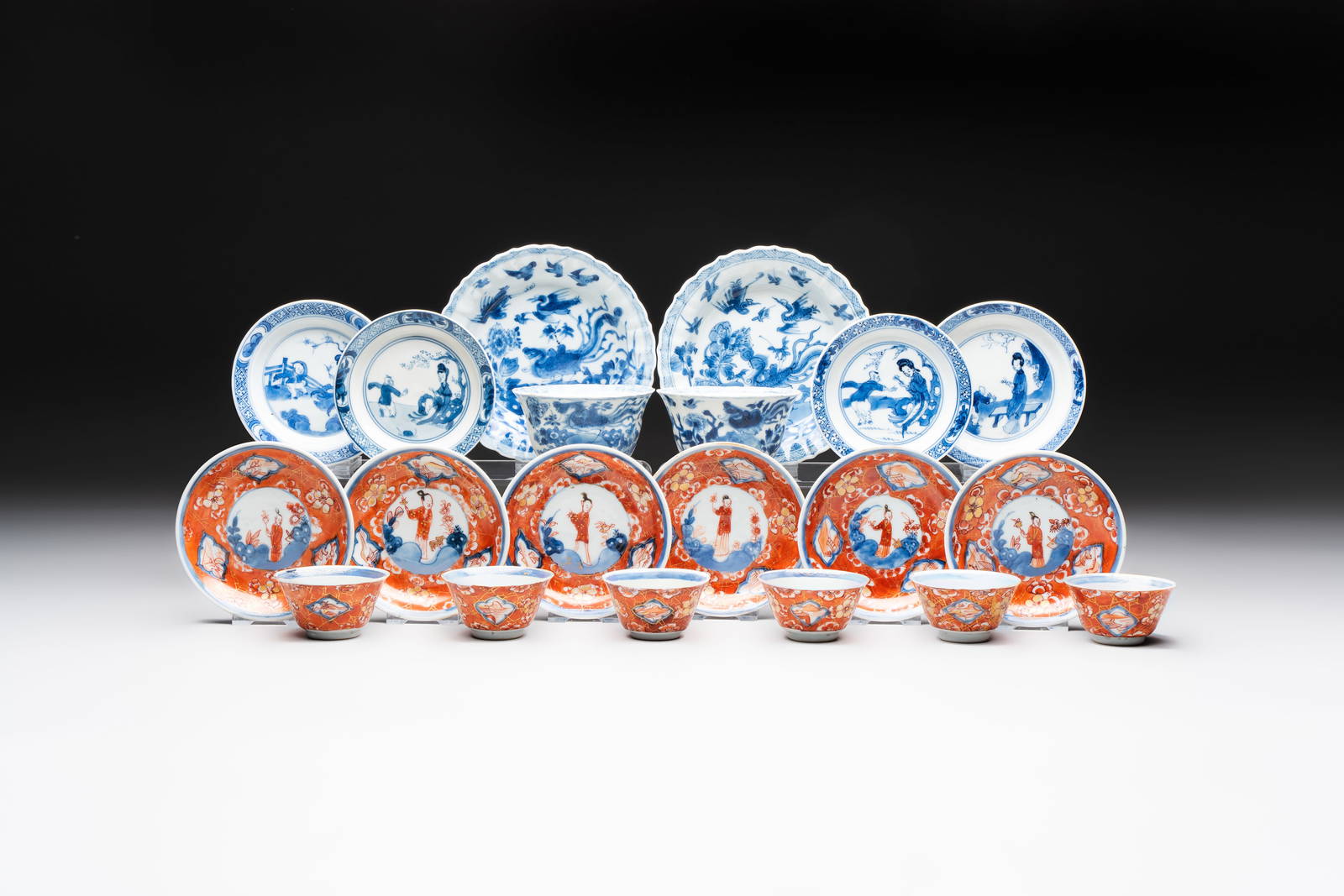 Eight Chinese blue, white and iron-red cups and twelve saucers, Kangxi/Yongzheng