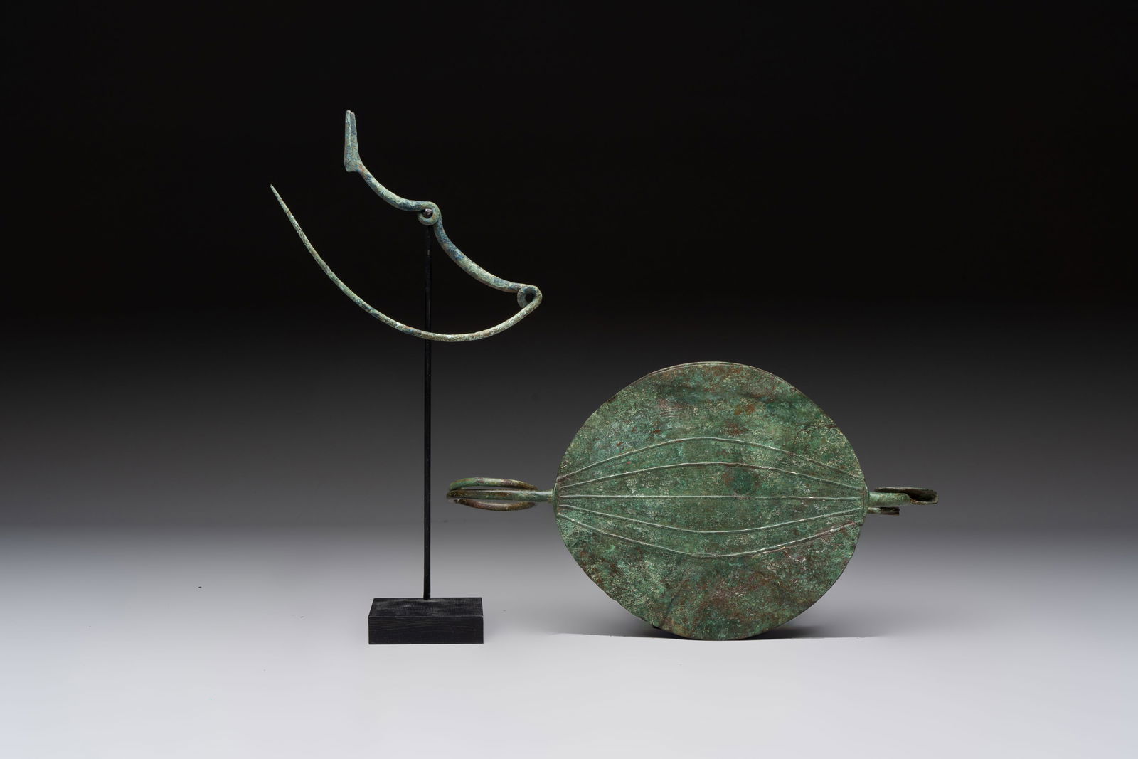 A large bronze Etruscan bow-shaped fibula and a Hungarian fibula with spring clasp, 12/7th C. B.C. (1 of 9)