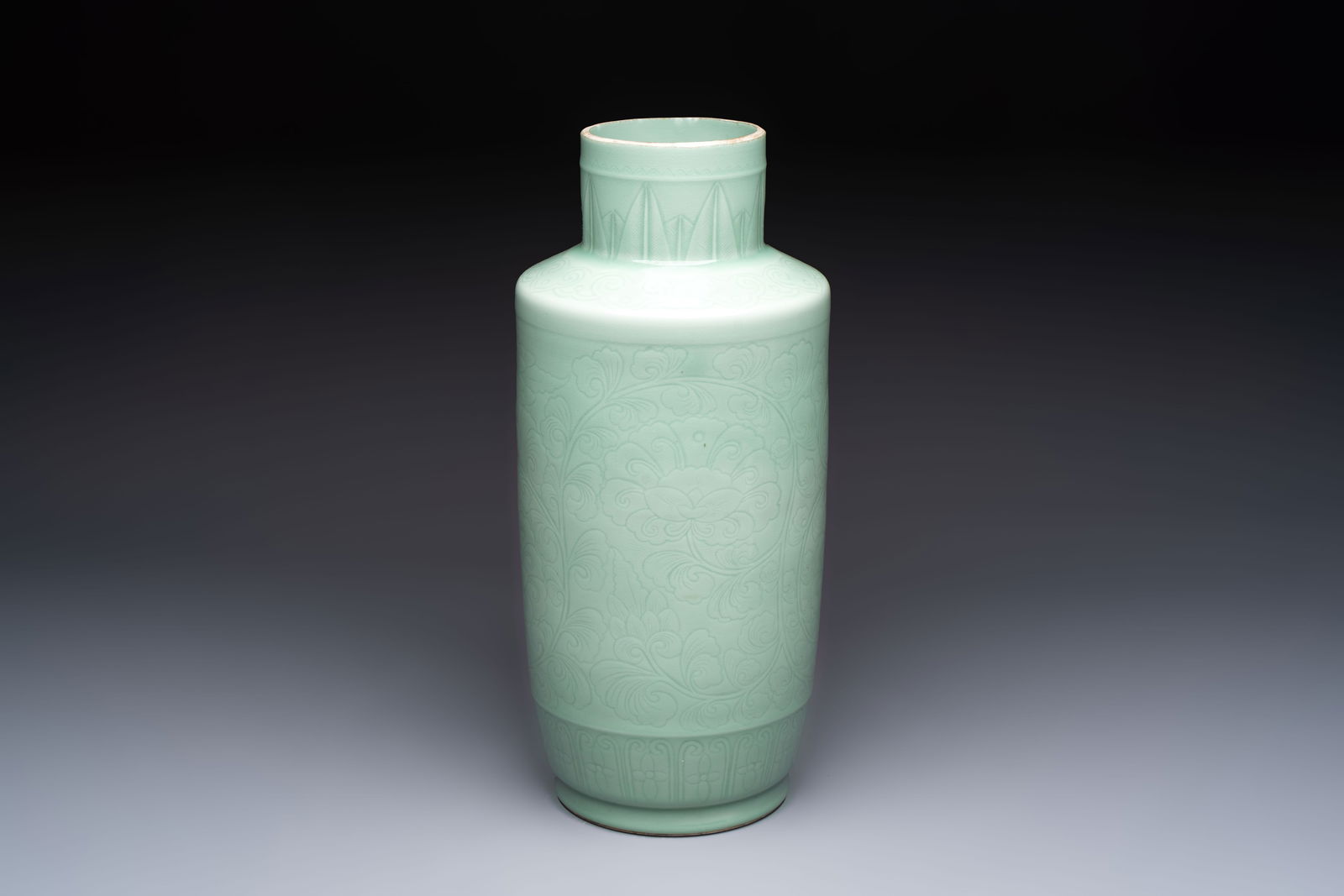 A Chinese celadon-glazed rouleau vase with incised floral design, 18th C. (1 of 7)