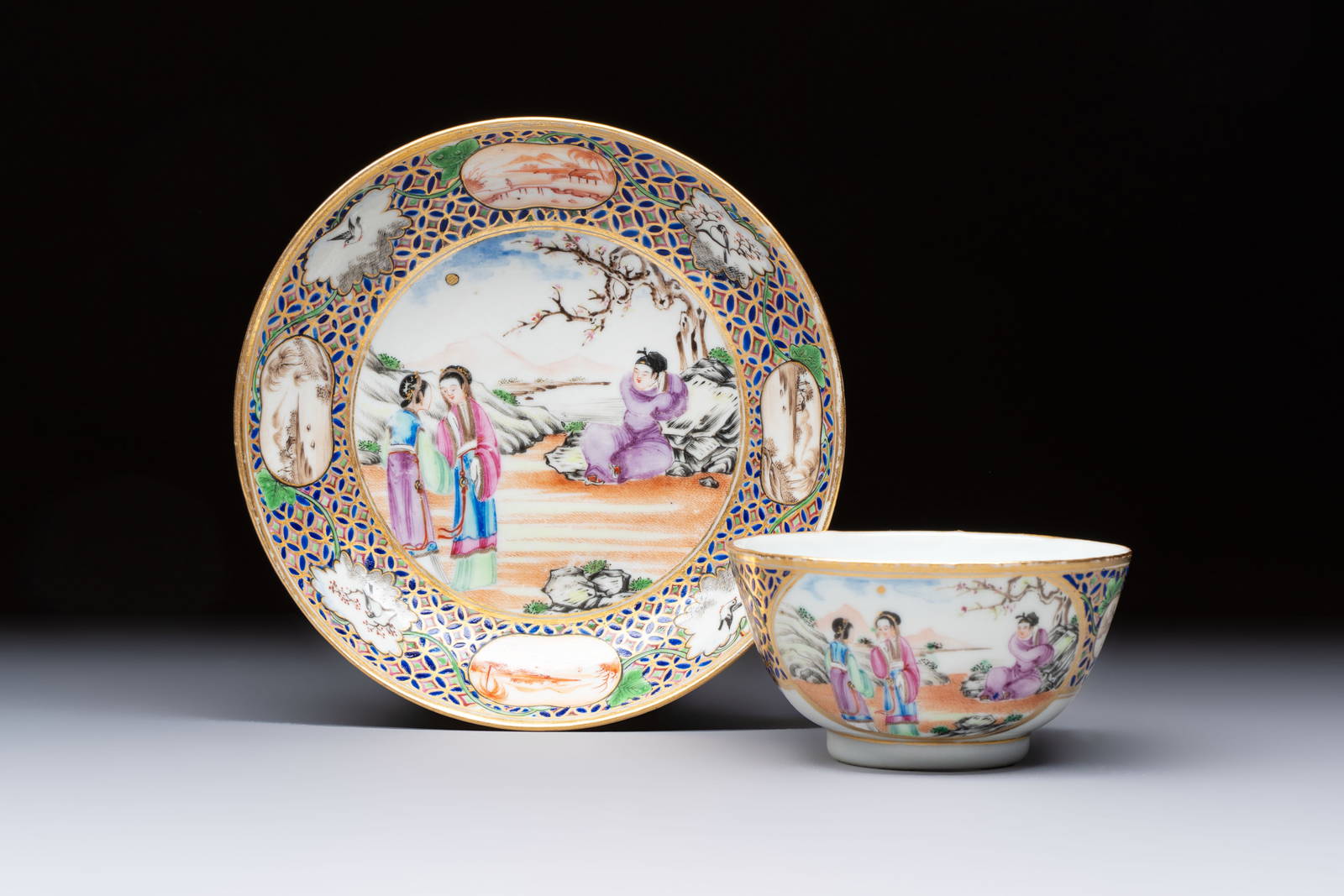 A Chinese famille rose gilt-decorated cup and saucer with figural design, Jiaqing
