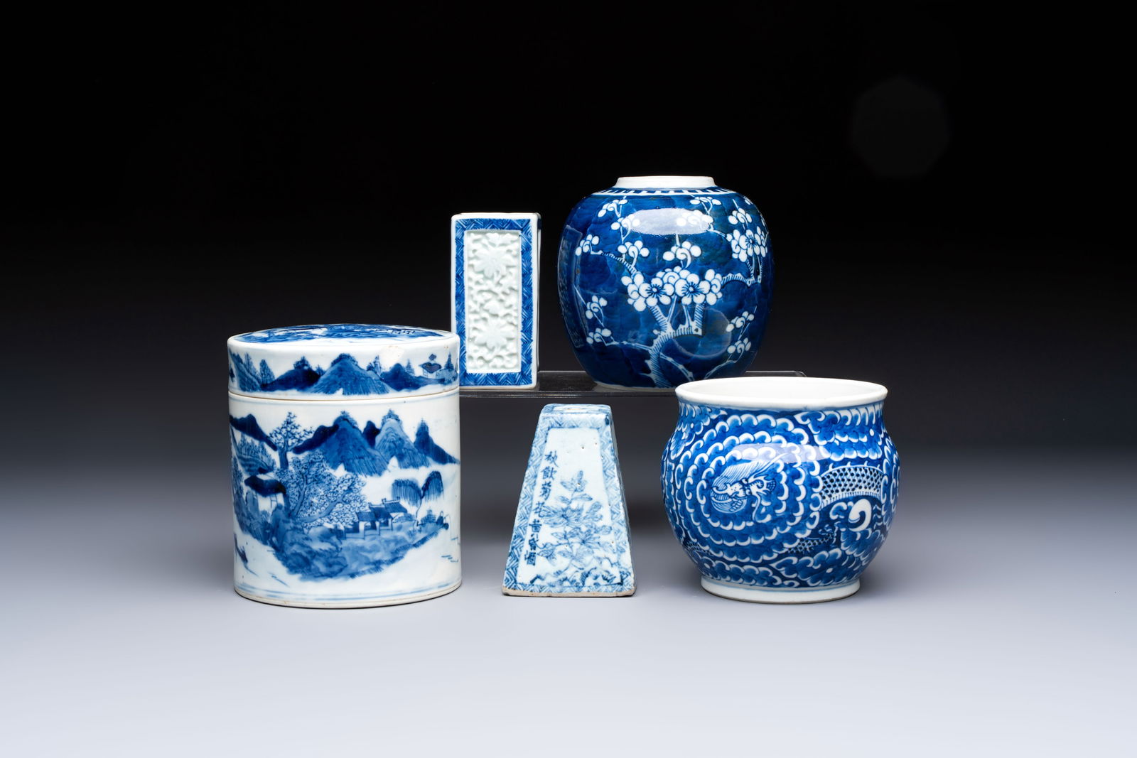 A Chinese blue and white square bitong, a 'Dragon' censer, a covered box, a vase and a paperweight,: A Chinese blue and white square bitong, a 'Dragon' censer, a covered box, a vase and a paperweight, Guangxu mark, 18/19th C. Dia.: 12,6 cm - H.: 14,5 cm (covered box) H.: 10,3 cm (the paper weight)