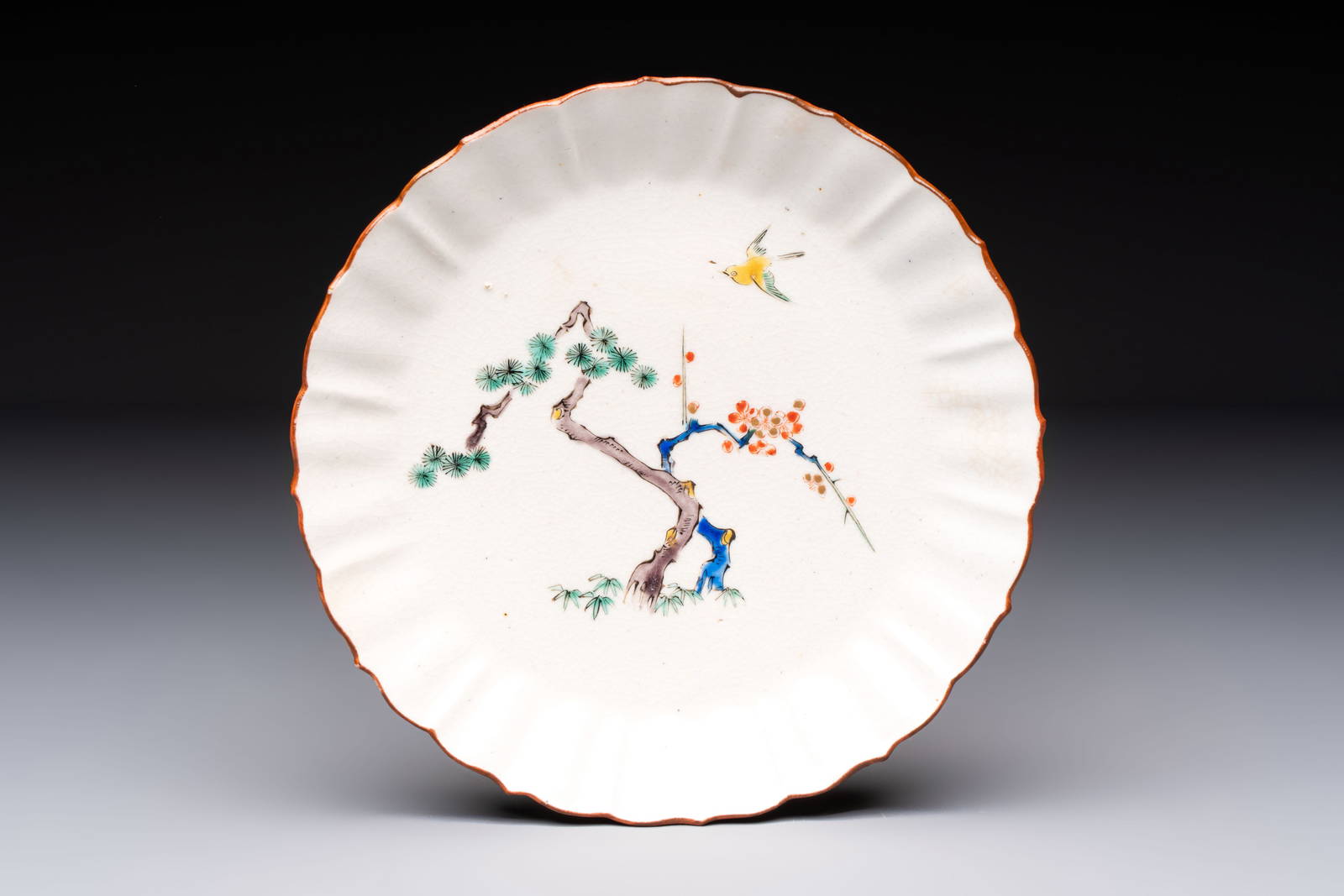 A Japanese Kakiemon-style 'Three Friends of Winter' plate, Edo, late 17/18th C.