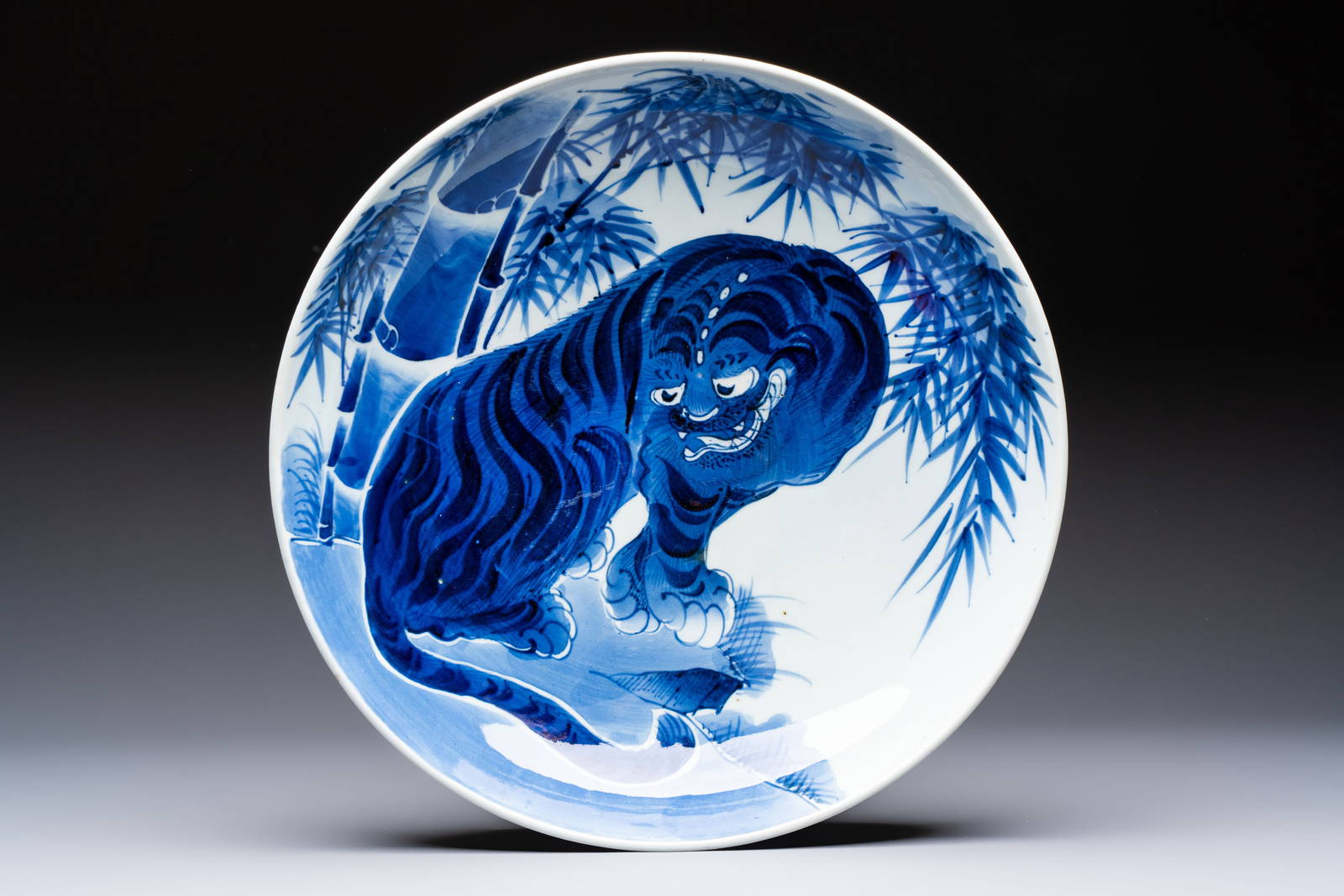 A large Japanese Arita blue and white 'Tiger' dish, Fuuki Chousun mark, late Edo to early Meiji,