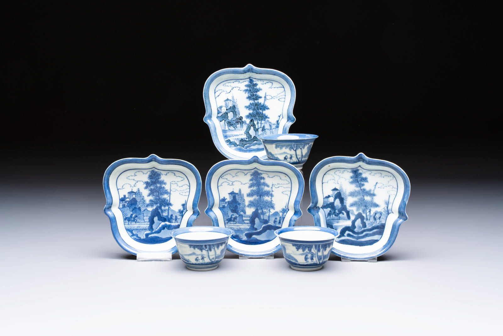 Three Japanese blue and white cups and four shield-shaped saucers, ca. 1700