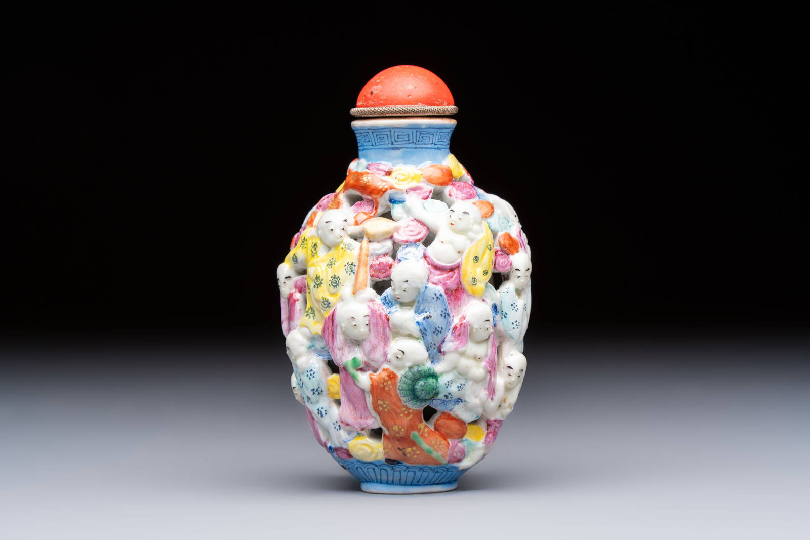 A Chinese famille rose moulded, reticulated and double-walled '18 Luohan' snuff bottle, Qianlong