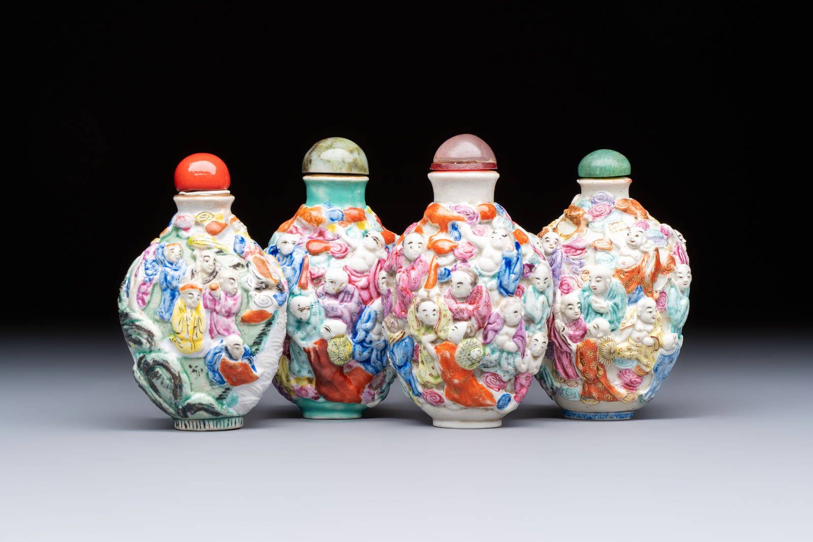Four Chinese famille rose moulded 'Luohan' snuff bottles, Qianlong marks, 19th C.
