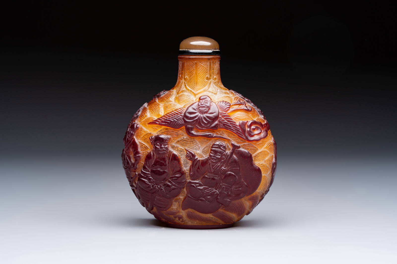 A very large Chinese brown-overlay amber glass 'Ba Xian Zhu Shou‘ table snuff bottle, 19th C.