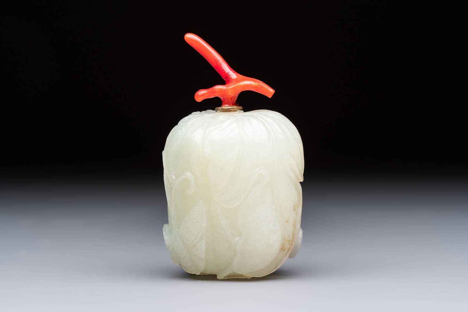A Chinese carved jade melon-form snuff bottle with a red coral stopper, 1820-1880