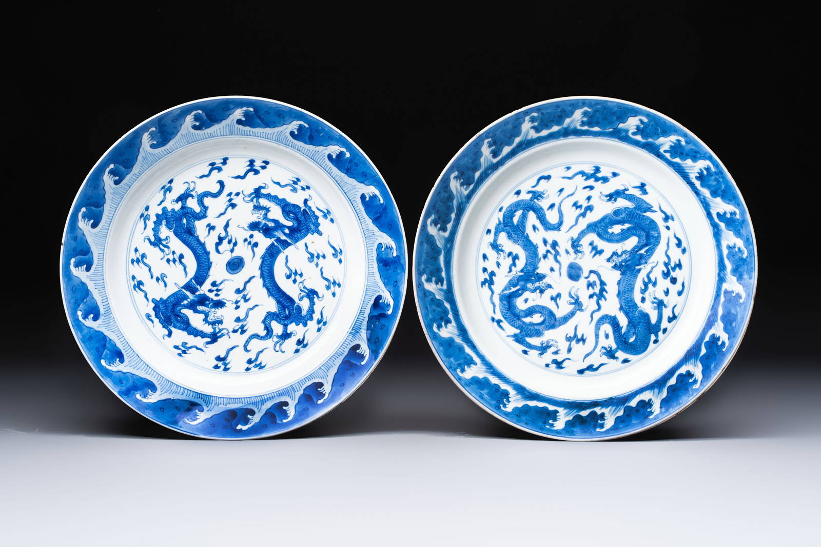 A pair of Chinese blue and white 'Dragon' dishes, Chenghua mark, Kangxi