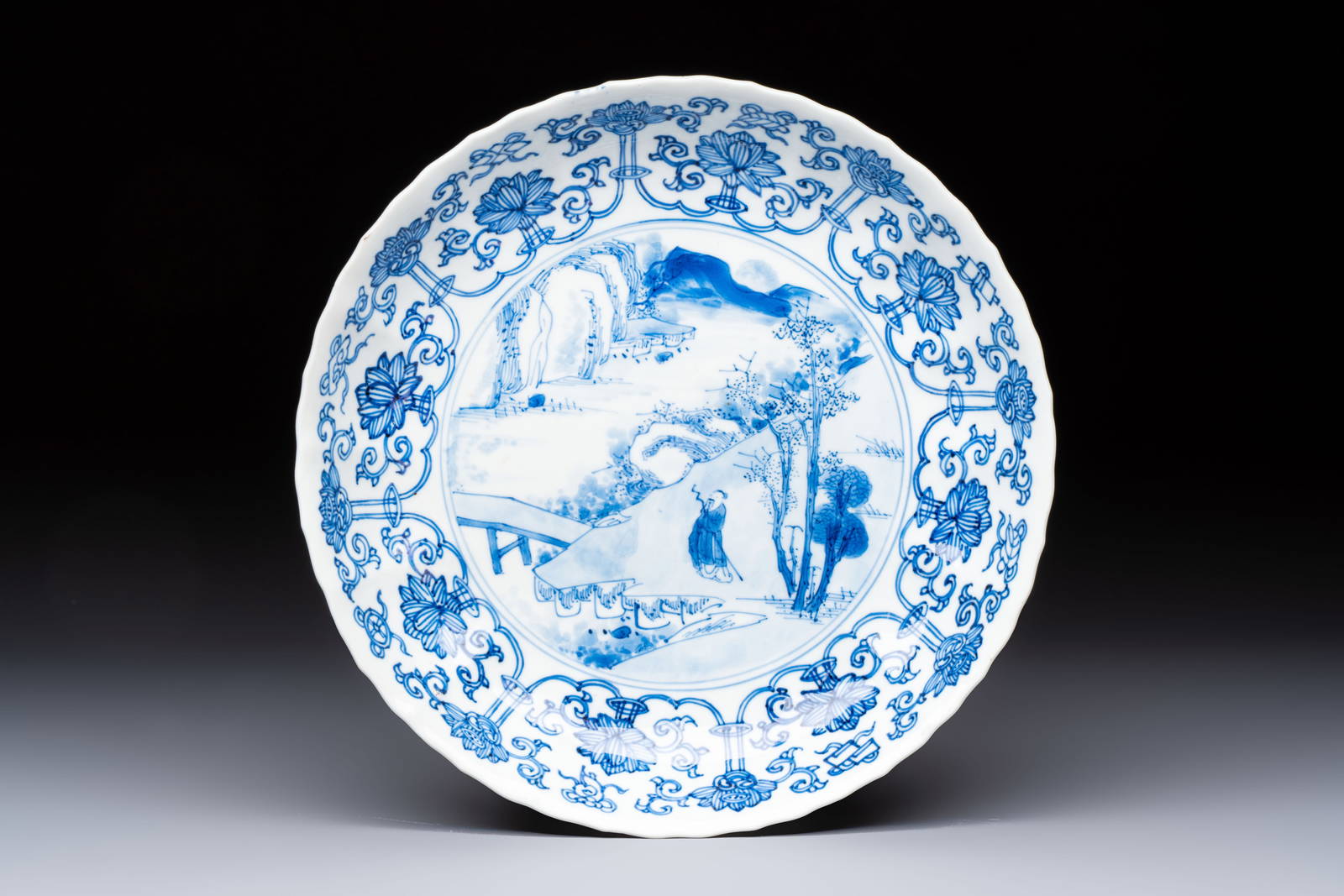 A very fine Chinese blue and white plate with a scholar in a landscape, Kangxi mark and of the