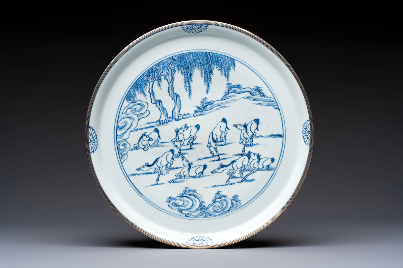 A rare Chinese silver-mounted blue and white 'Eight Horses of Mu Wang' dish, Kangxi