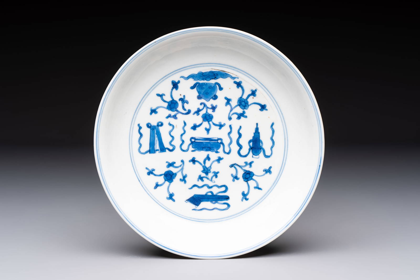 A Chinese blue and white 'Buddhist Symbols' plate, Chenghua mark, Kangxi