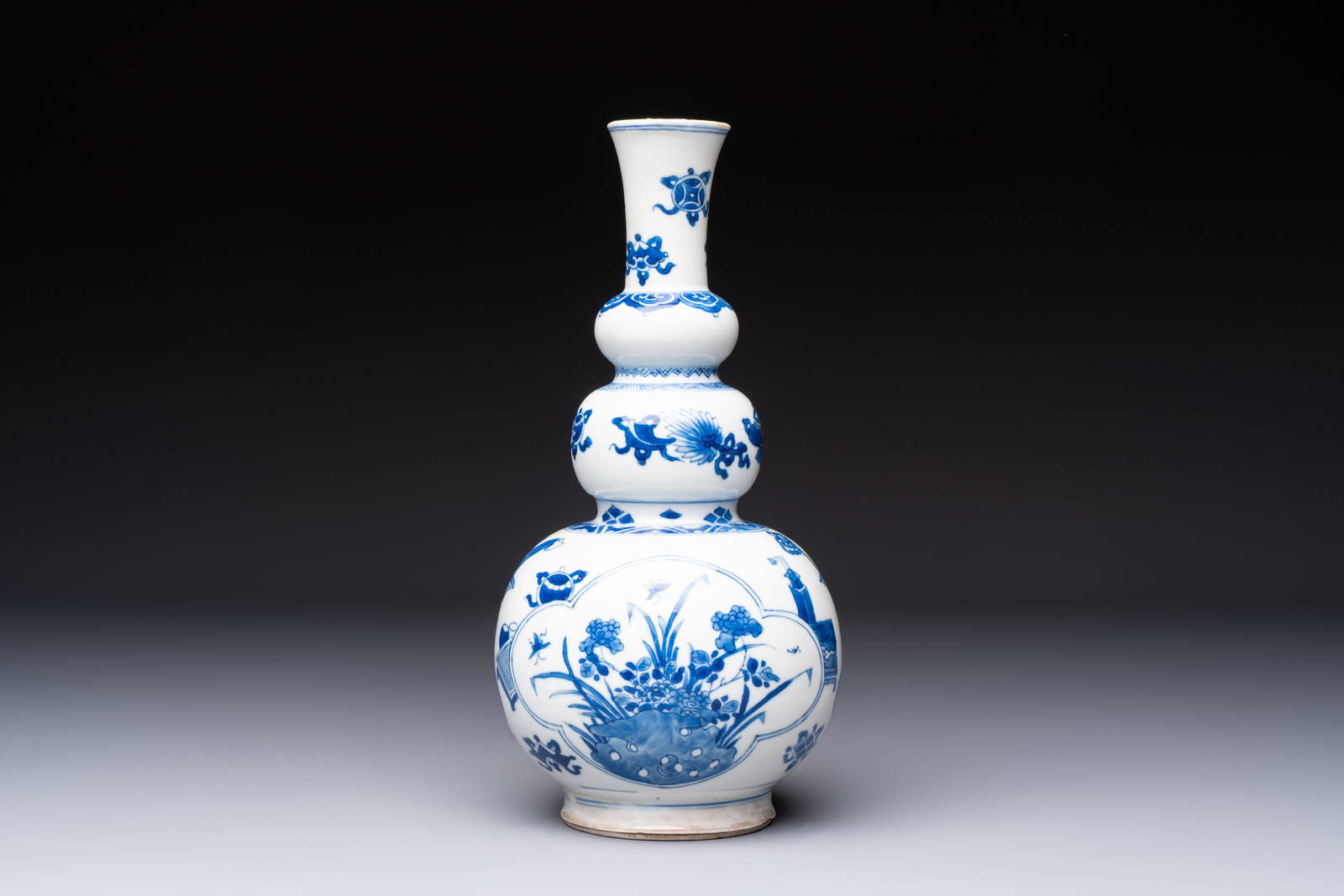 A Chinese blue and white double gourd 'Antiquities' vase, Kangxi
