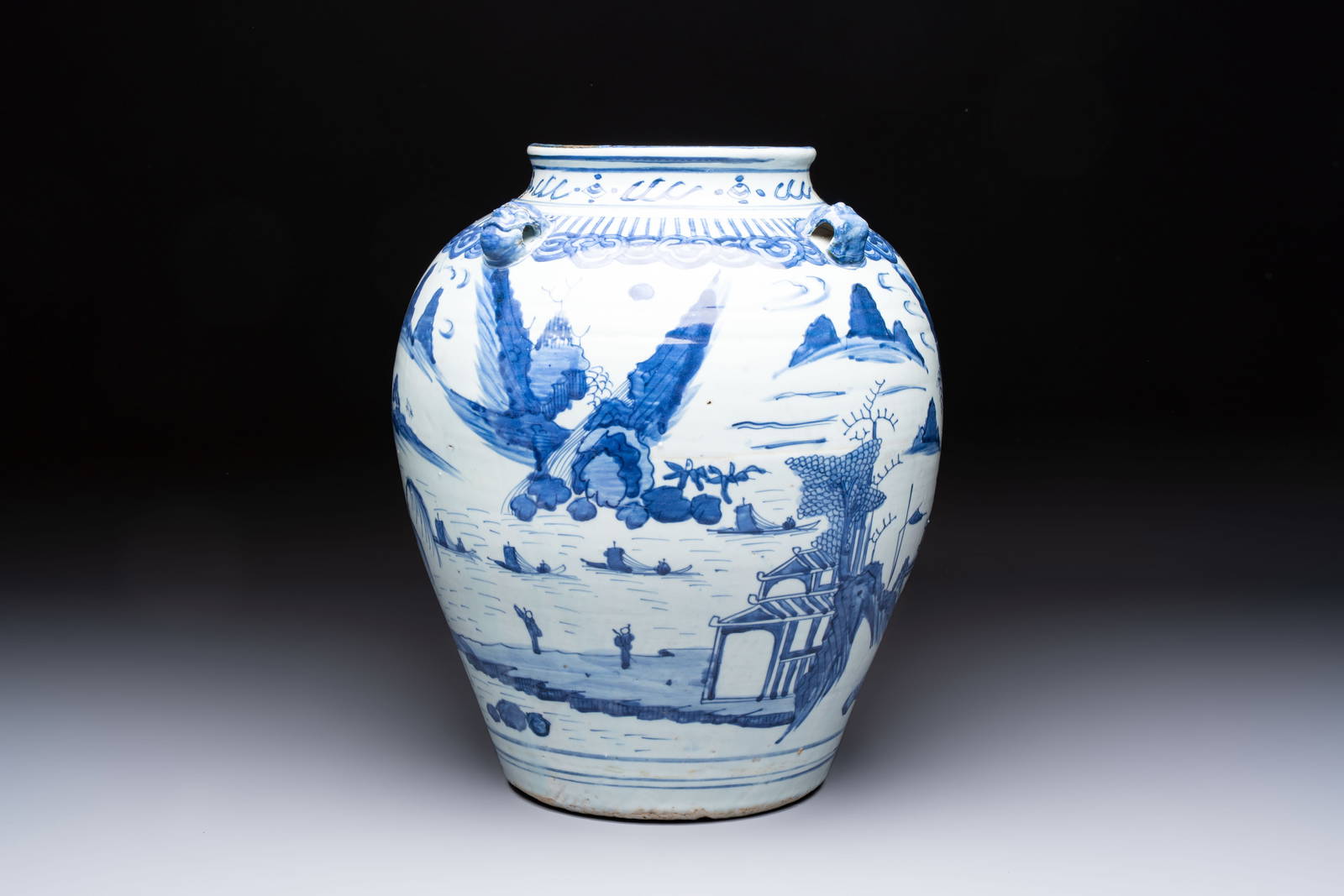 A Chinese blue and white 'Mountainous Landscape' vase with four lion-form handles, 16/17th C.
