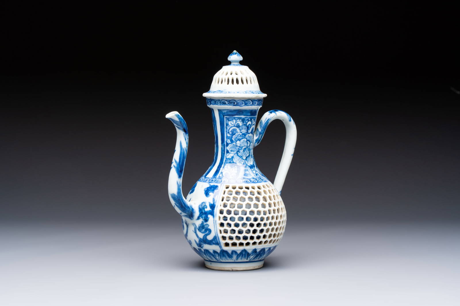 A rare Chinese blue and white reticulated double-walled ewer and cover with floral design, Kangxi