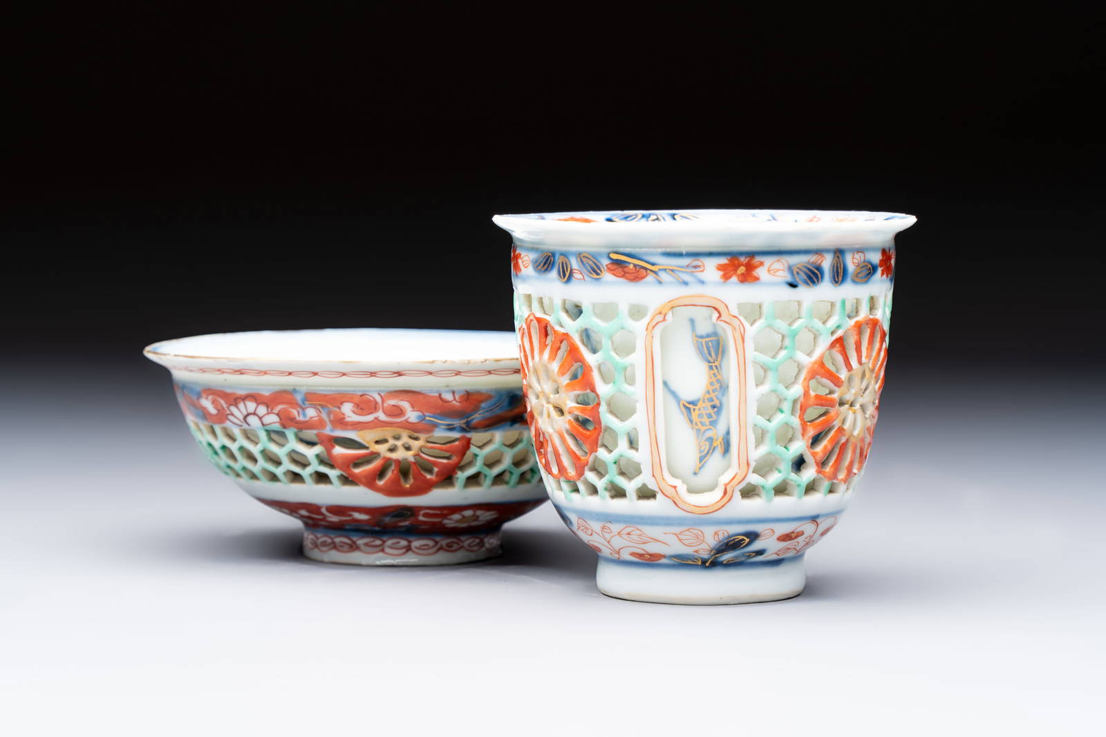 A rare Chinese famille verte reticulated double-walled cup and saucer, artemisia leaf mark, Kangxi