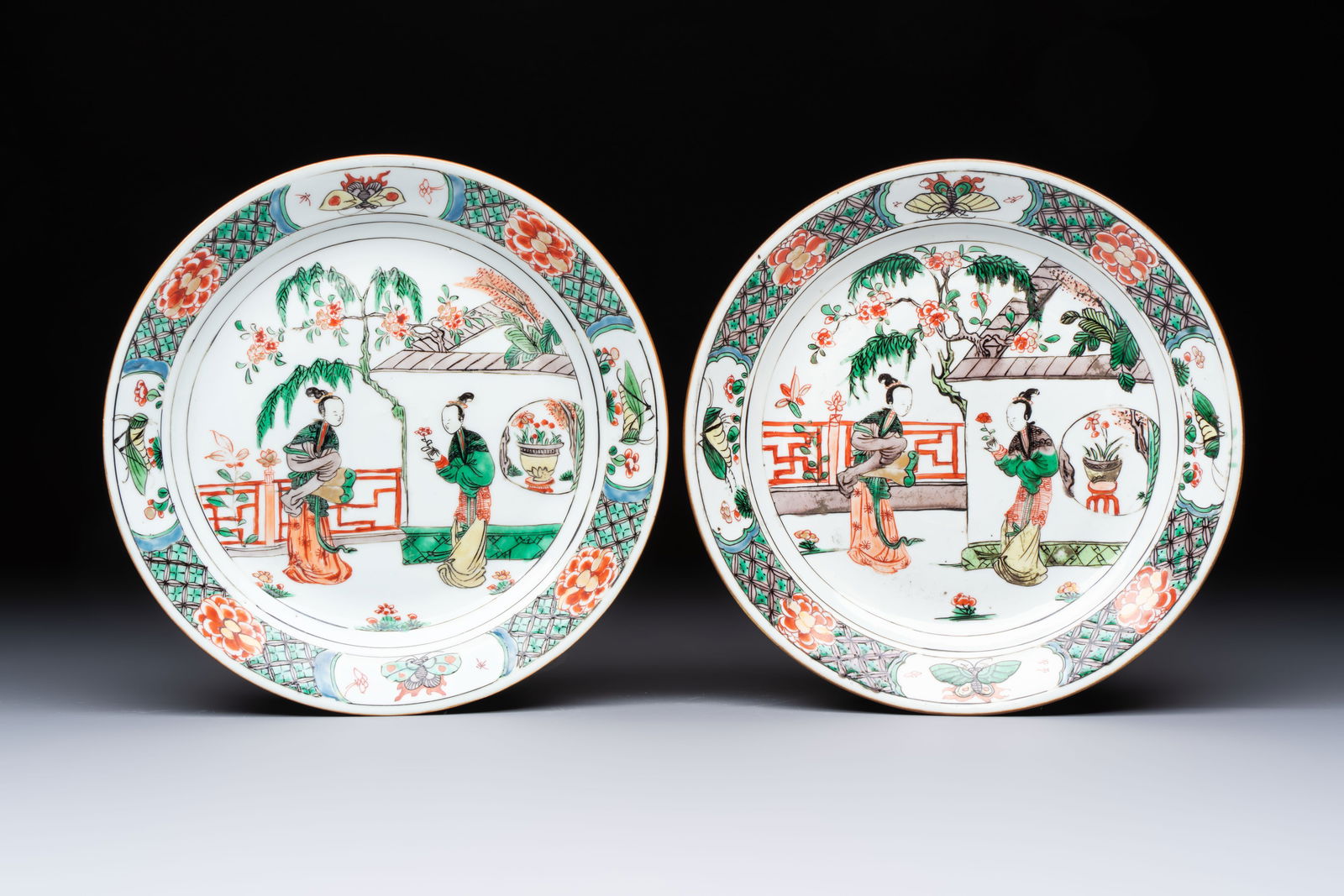 A pair of Chinese famille verte 'Ladies in a Garden' plates, Kangxi (1 of 2)