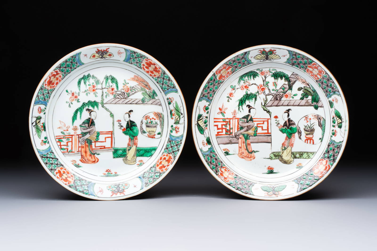 A pair of Chinese famille verte 'Ladies in a Garden' plates, Kangxi