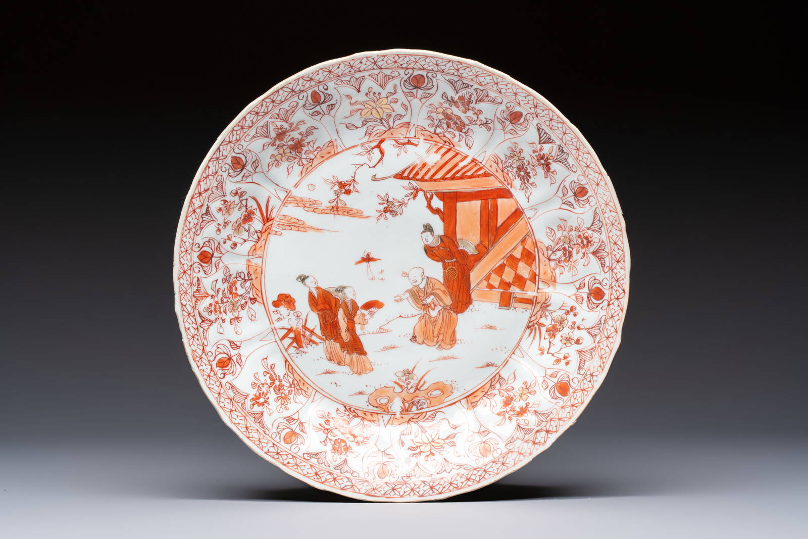 A Chinese iron-red and gilt-decorated dish with a garden scene, Kangxi