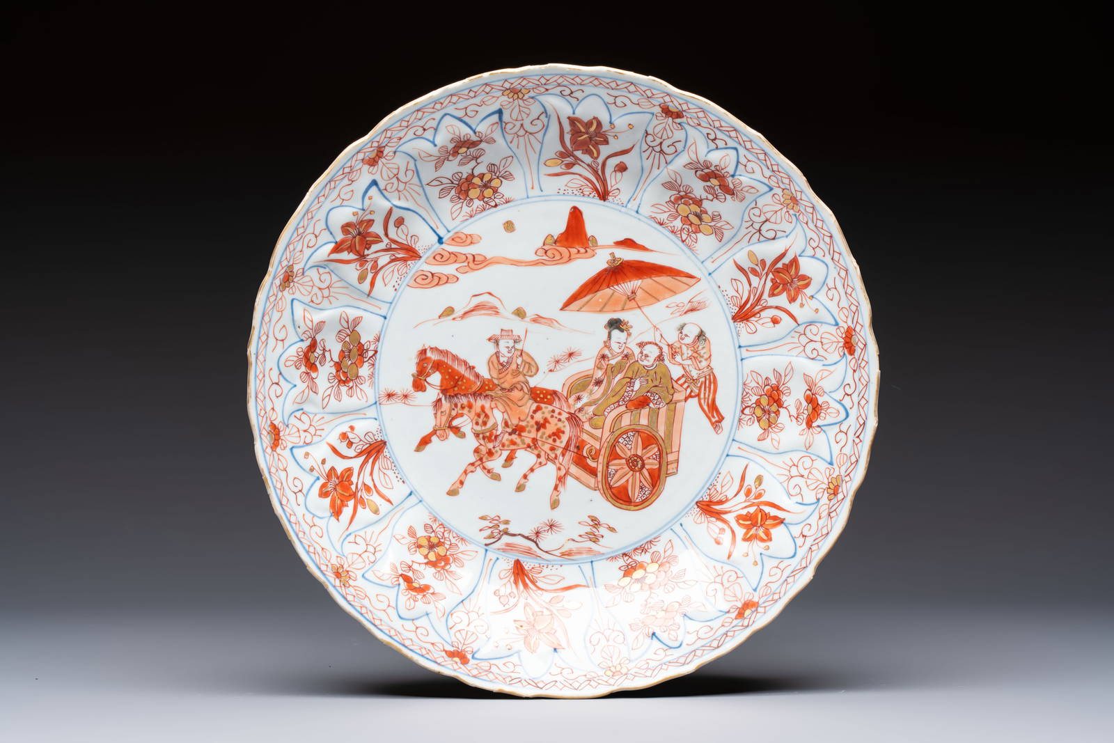 A Chinese iron-red and gilt-decorated dish with a courtly carriage scene, Kangxi