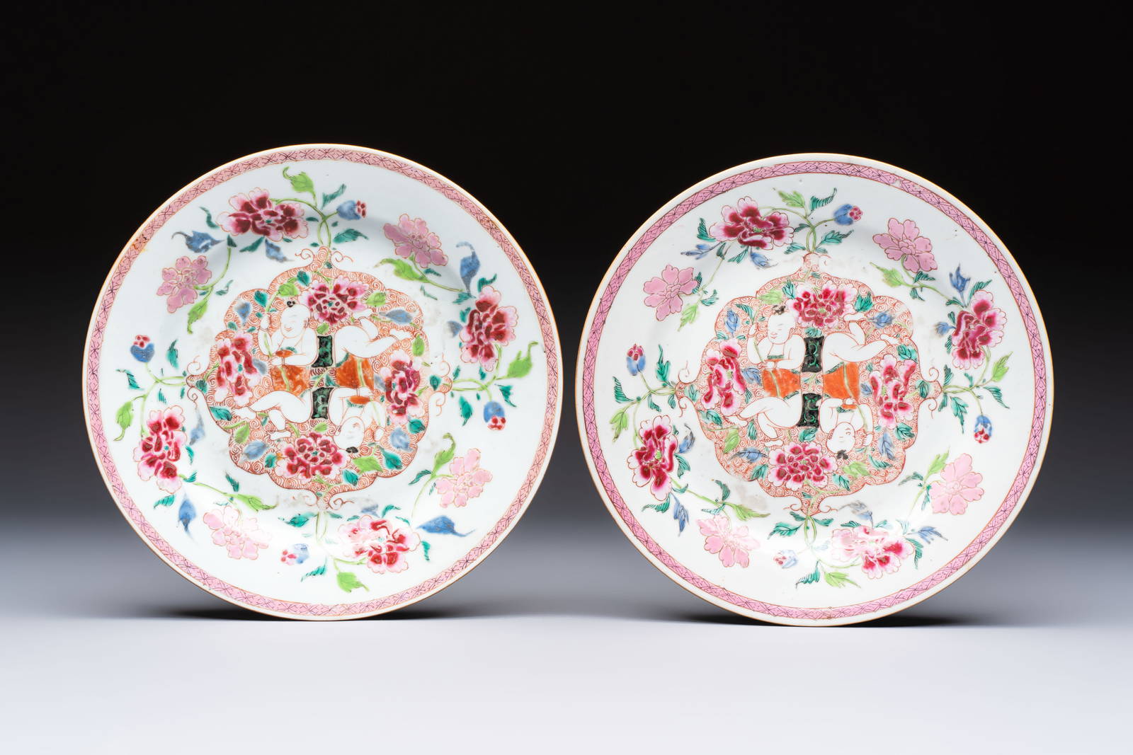 A pair of Chinese famille rose 'He He Er Xian' plates, Yongzheng/Qianlong