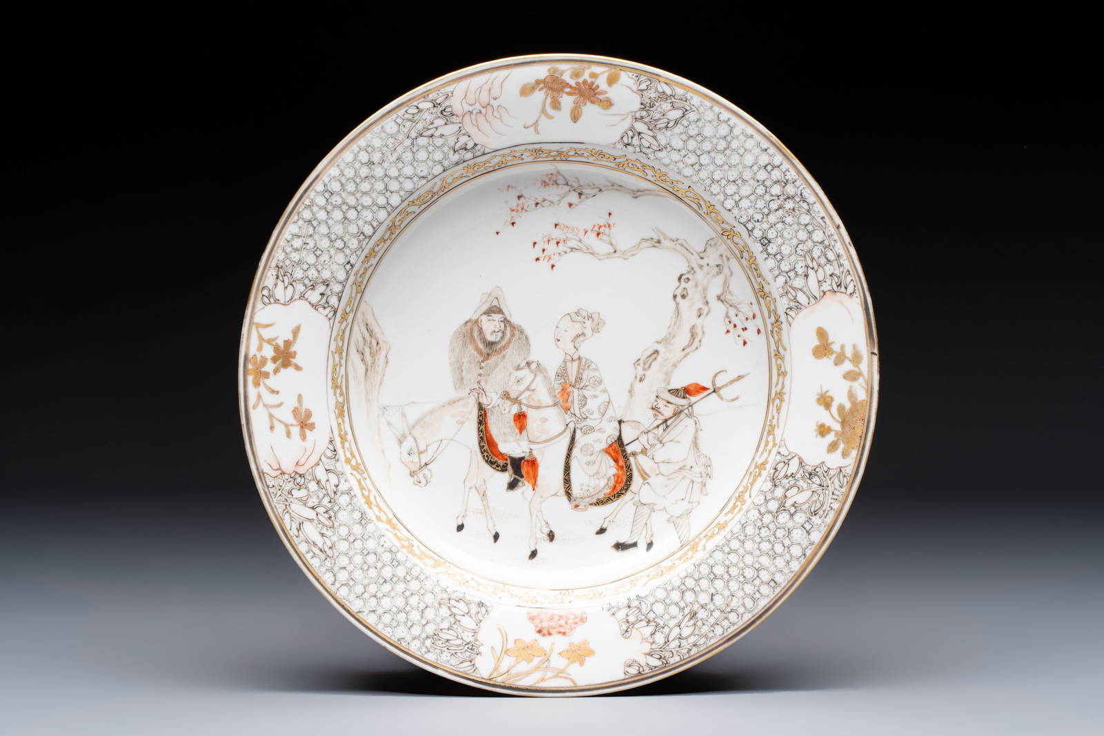 A fine Chinese grisaille, iron-red and gilt-decorated 'Riders on Horseback' plate, Yongzheng