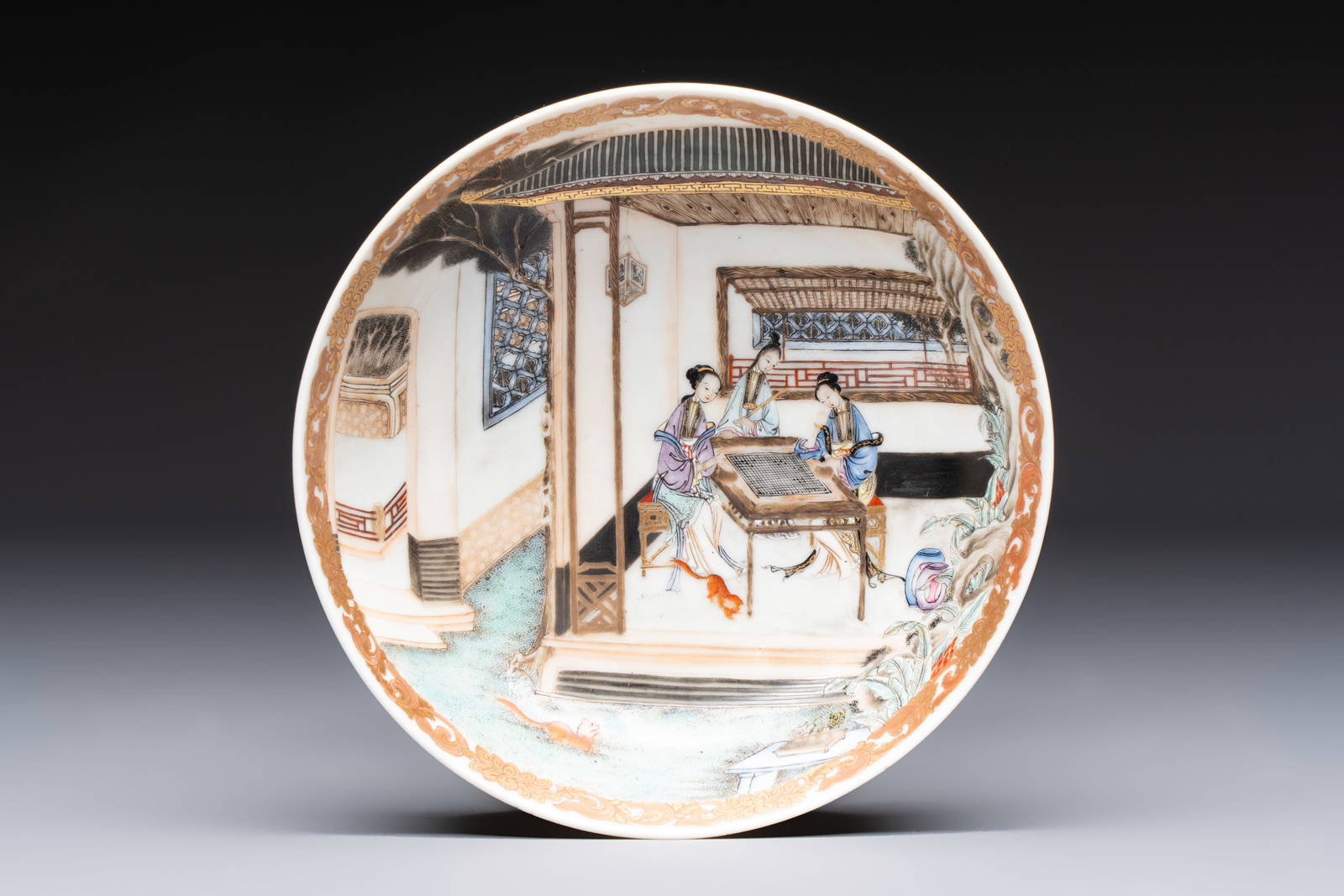 A Chinese famille rose 'Ladies Playing Go' saucer, Yongzheng