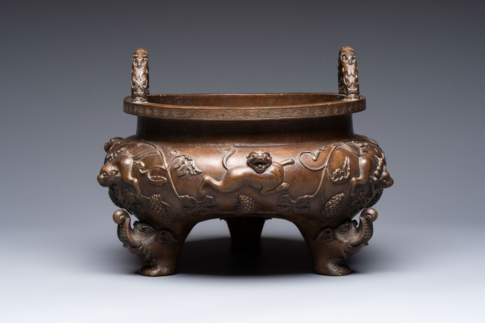 A rare Chinese bronze tripod censer with relief mythical animal and grape design, Xuande mark, 19th (1 of 6)